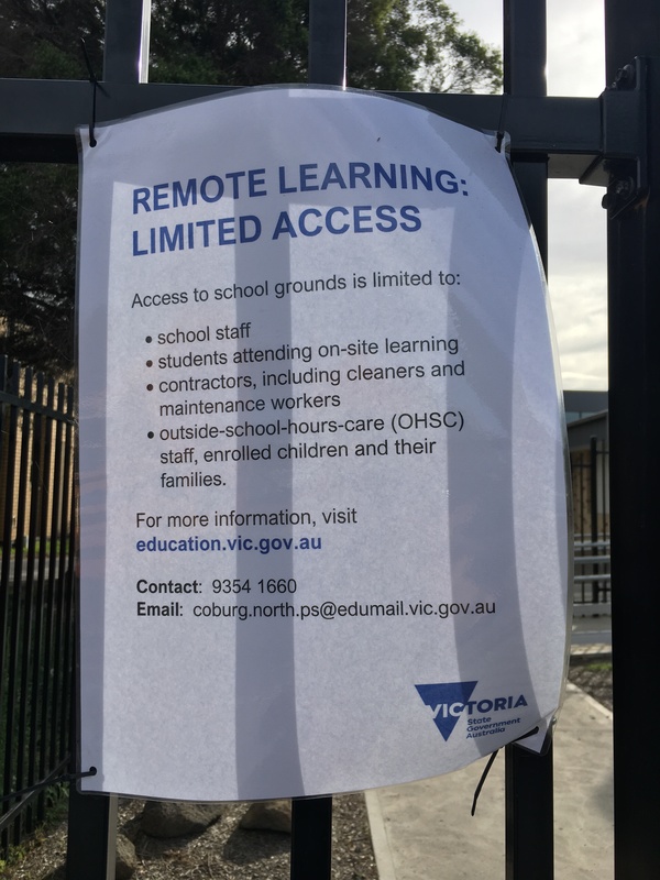 A flyer for school remote learning on a black gate. 