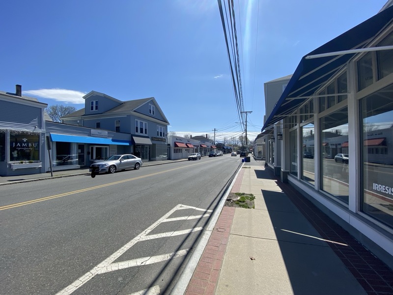 Marblehead, Massachusetts main street mostly empty with a few cars parked.  