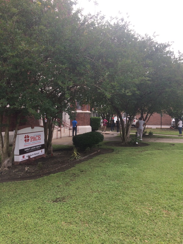 people in line at a brick building 