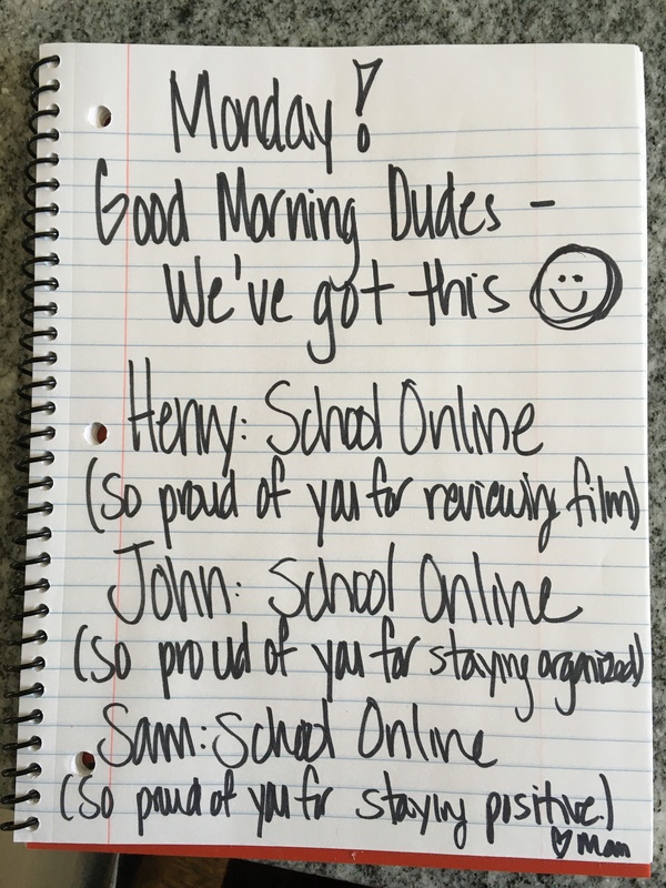 A note that says "Monday! Good morning dudes- we've got this. Henry: School online (so proud of you for reviewing film). John: School online (so proud of you for staying organized). Sam: School online (so proud of you for staying positive). heart Mom."