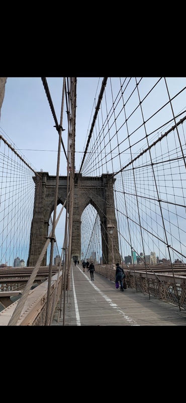 This is a picture taken showing the walking area on the top of a large bridge. 