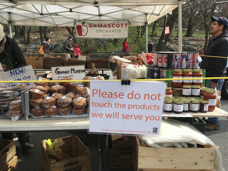 A sign at a farmers market that says "Please do not touch the products we will serve you."