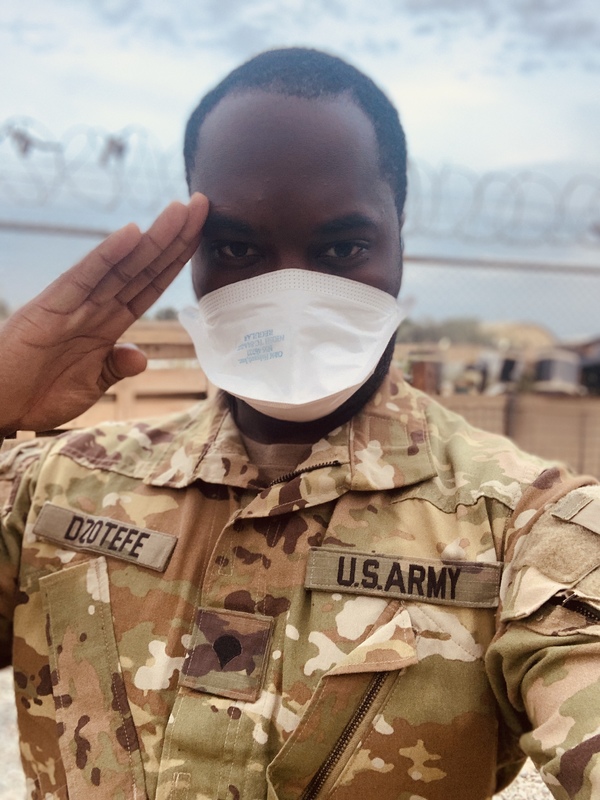 A person in a military uniform saluting. 