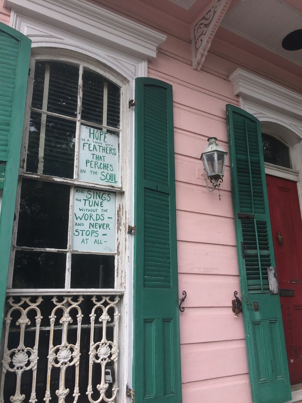 a green sign about hope on a window