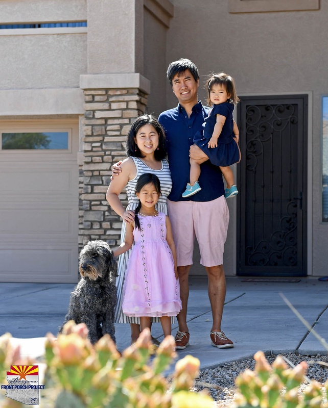 A family posing with a dog. 