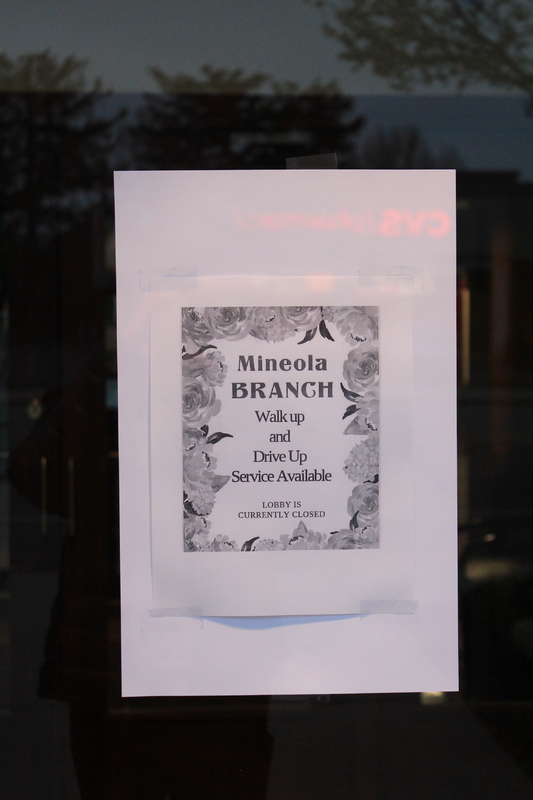 Sign that says: "Mineola Branch. Walk up and drive up service available. Lobby is currently closed." 