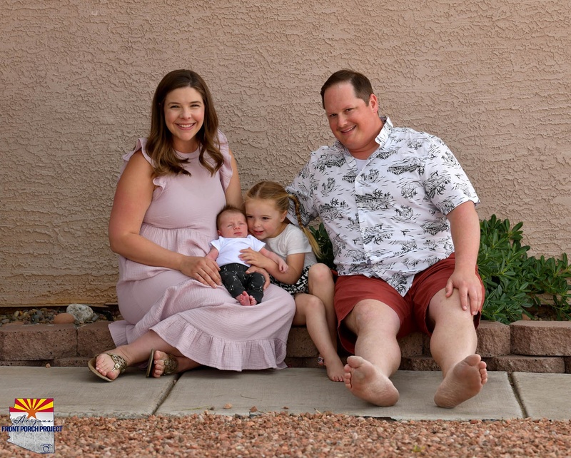 A family posing on a walkway. 