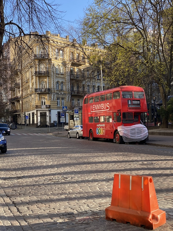 A double decker bus with a mask on the front. 