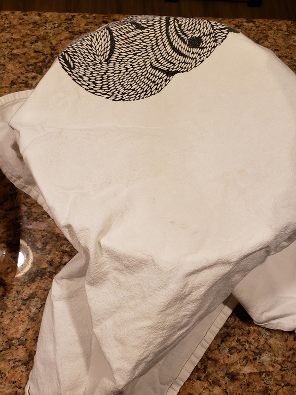 Photo of a bowl covered with a hand towel.