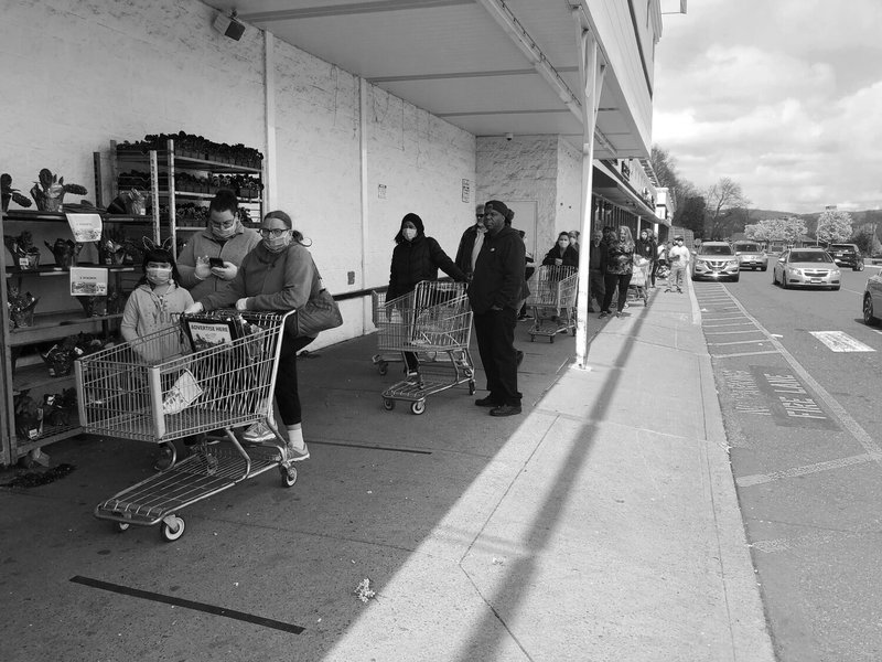 People waiting in line at a store. 