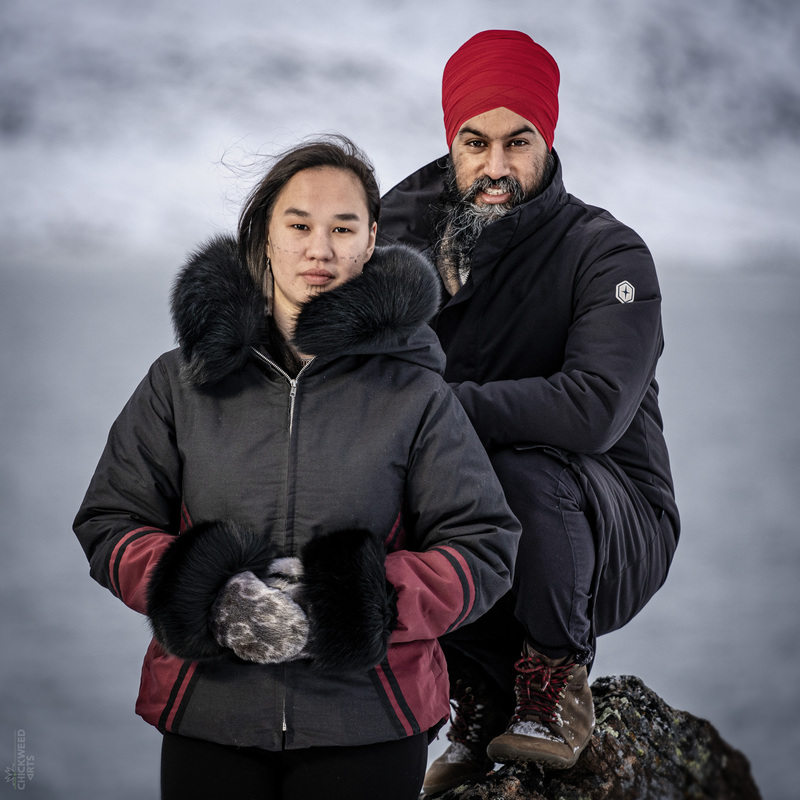 This is a picture of two Canadian men posing for a picture outside wearing heavy winter coats. 