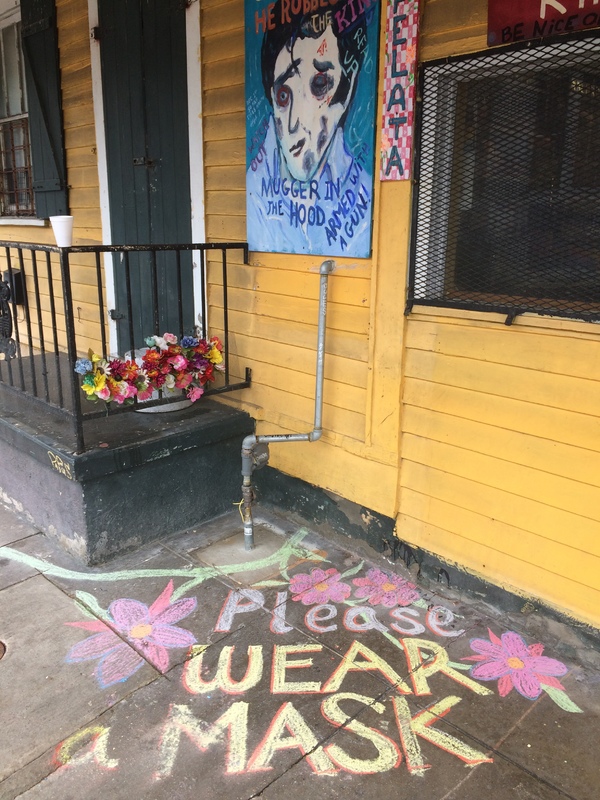 Sidewalk chalk in front of a building. 