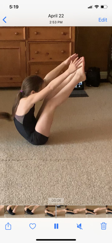 A child stretching and doing gymnastics. 