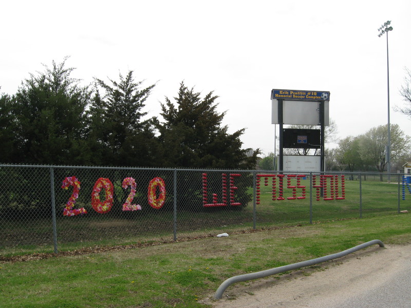 red words on a fence stating "2020 we miss you"