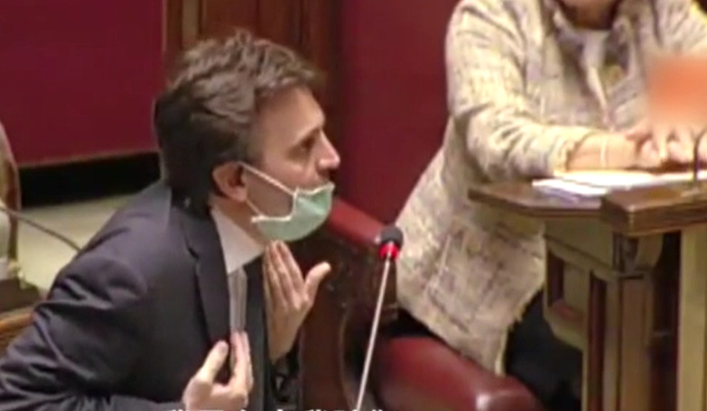 An Italian councilor wearing a mask.