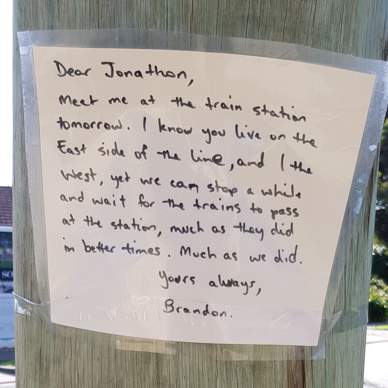 Picture of a message left at a train station for the writers friend, offering that they meet up at the station and catch up like old times. 