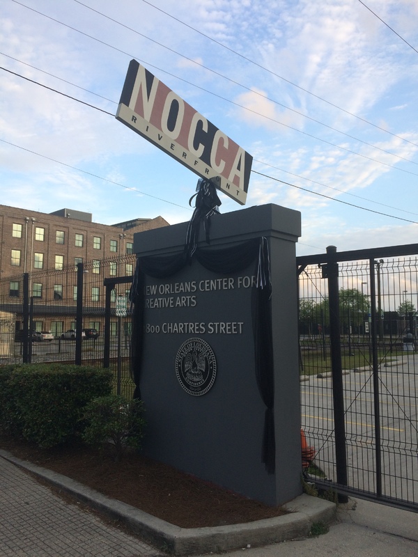 The entrance for the New Orleans Center for Creative Arts decorated with black ribbon. 