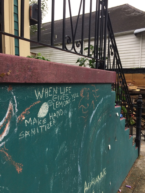 Chalk art on a stairway outside a house. 