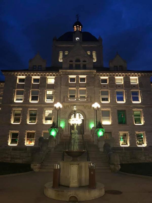 Green lights in front of a building. 