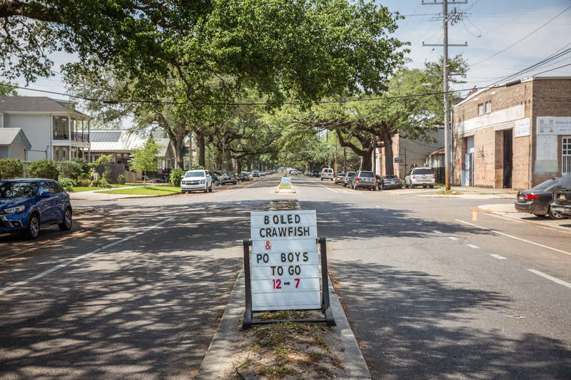 Sign that says "boiled crawfish & po boys to go 12-7."