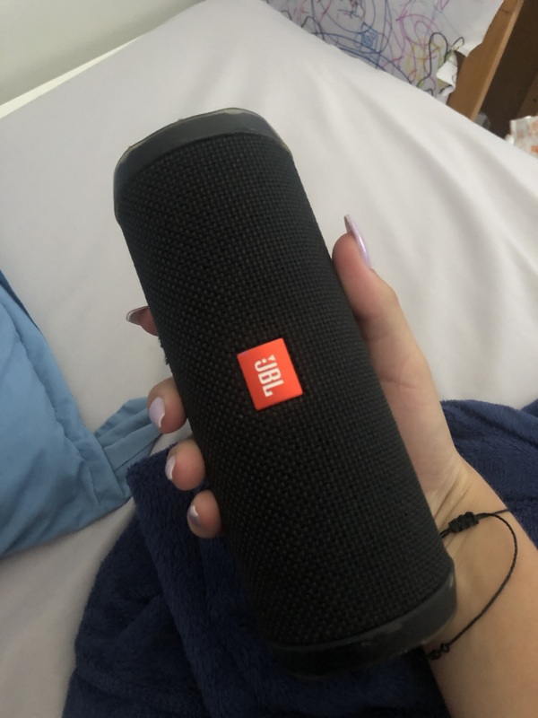 A black JBL brand speaker. 