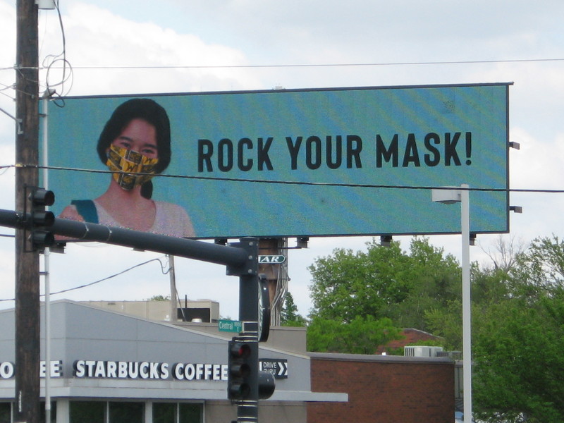 Billboard with a person wearing a facemask with text, "ROCK YOUR MASK!"