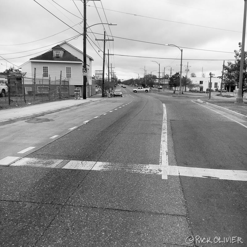 A road with barely any cars on it. 