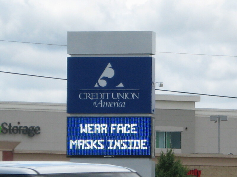 A bank sign reading "Wear Face Masks Inside". 