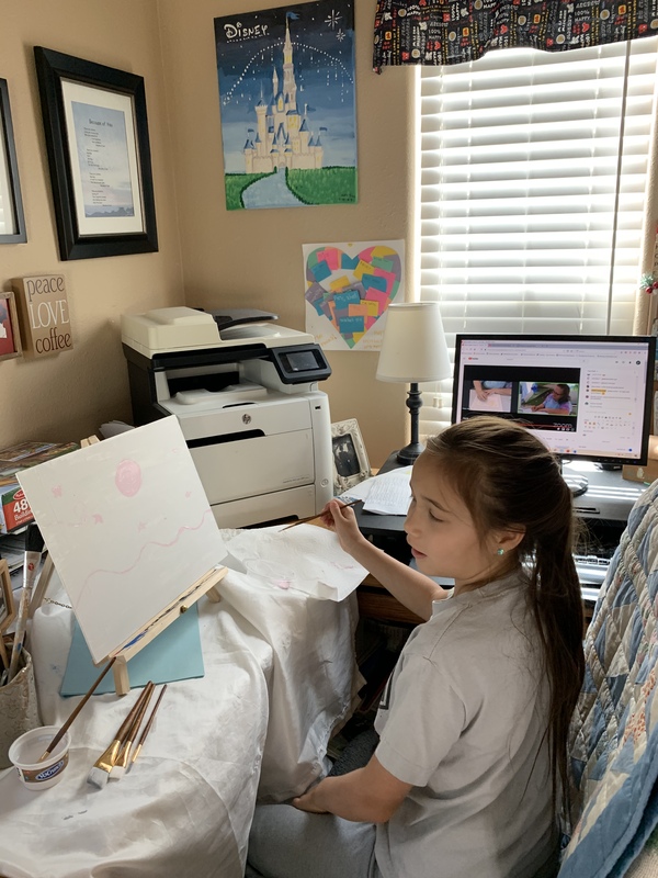 A photo of a child painting.