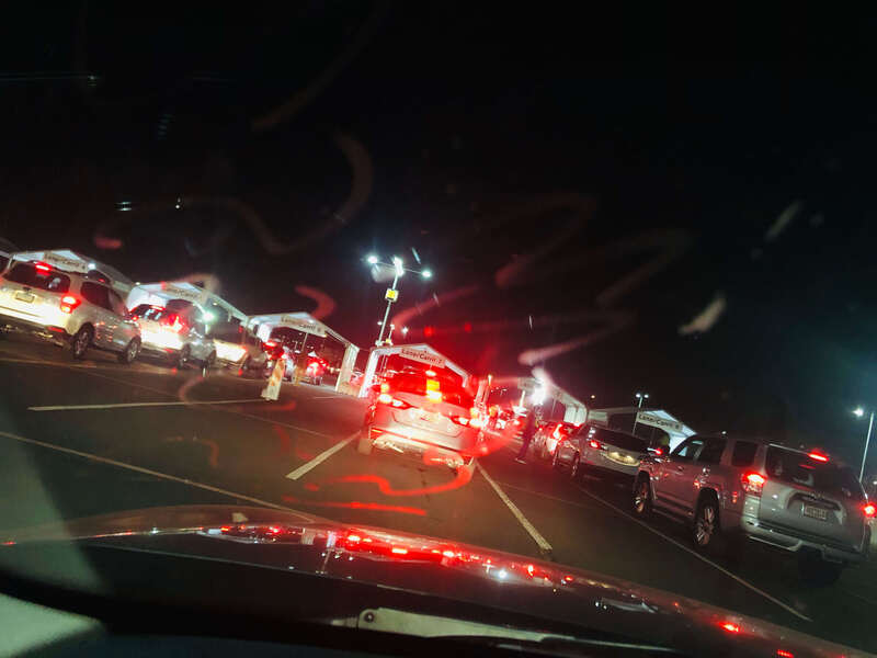 Multiple lanes of cars lined up for drive-thru vaccination. 