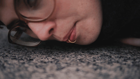 A face next to a trash can.