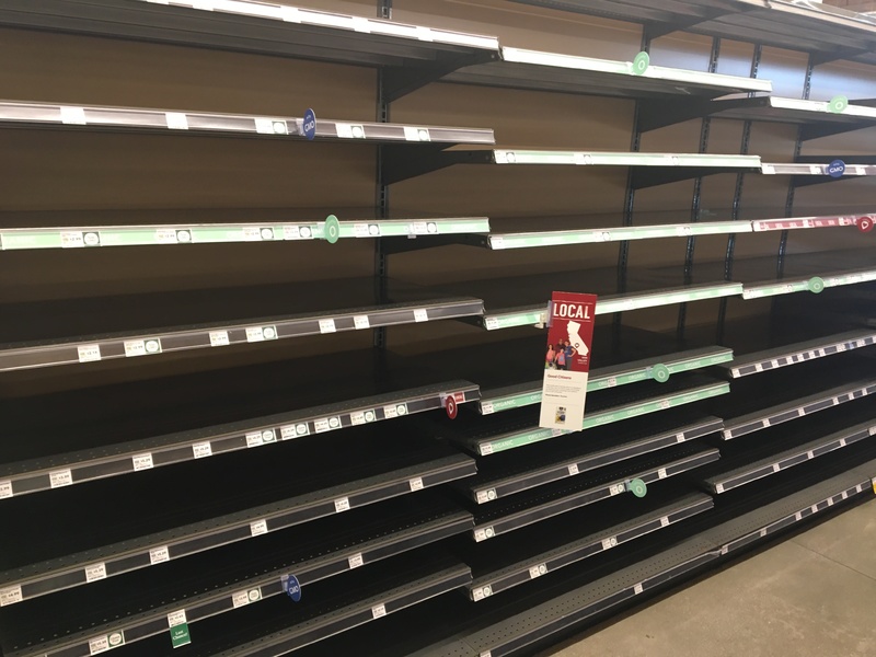 Rows of empty shelves in a store. 