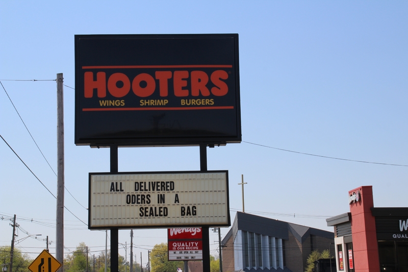 A restaurant sign reading "All Delivered Orders in a Sealed Bag".