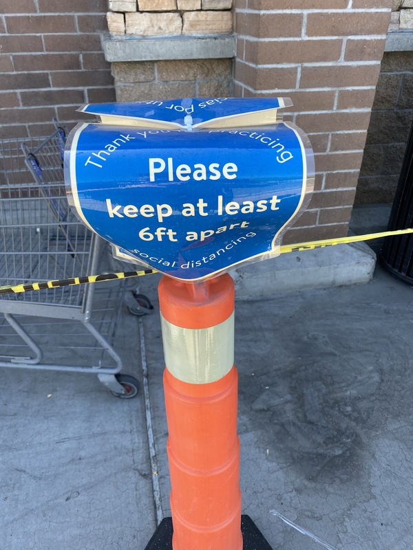 A blue sign on an orange pole. 