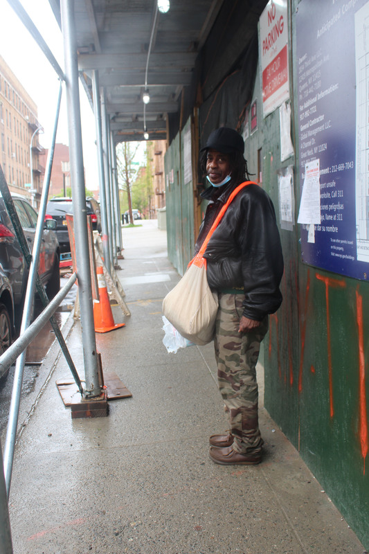 A man with a satchel and a mask. 