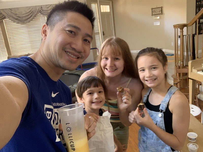 Two adults and two children enjoying fair food at home. 