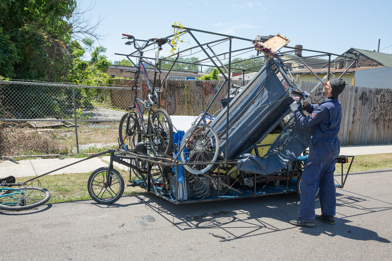 A person putting scrap in a metal cage.