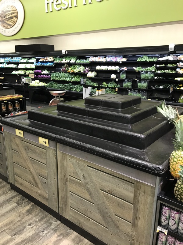 An empty stand for holding fruit in a grocery store. 