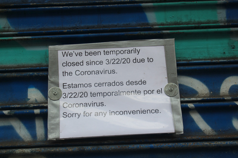 A white sign warning that a store is closed.