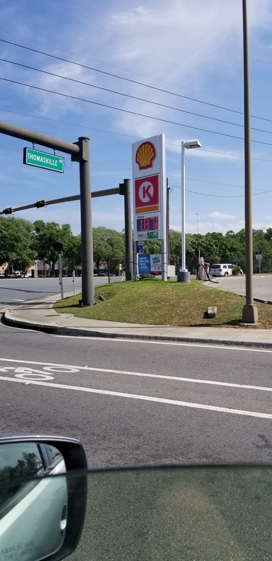 A gas station sign showing prices. 