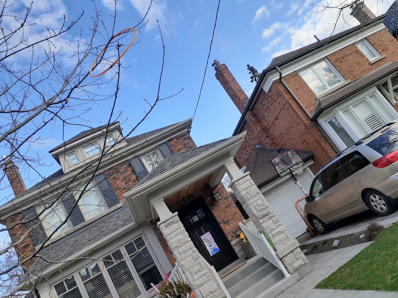 This is a picture taken of a house from a residential street. 