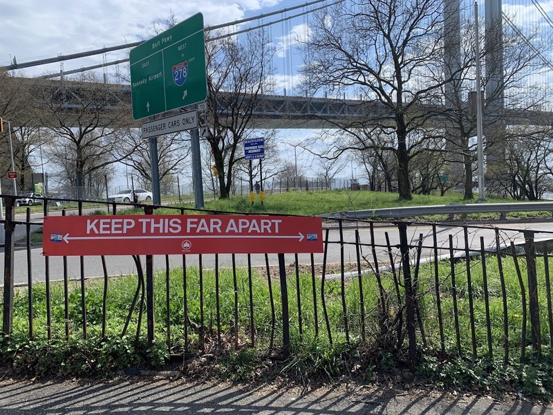 a red sign showing the distance people need to say apart