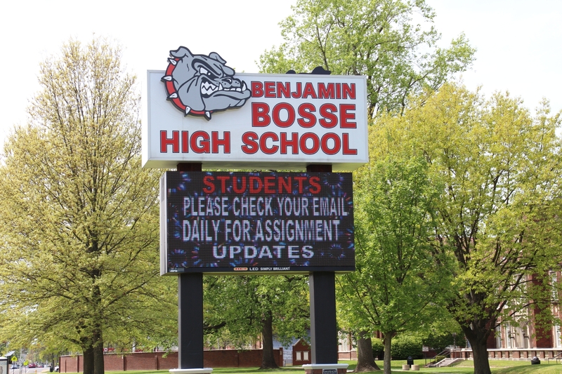 A school sign reading "Students, Please Check Your Email Daily for Assignment Updates". 