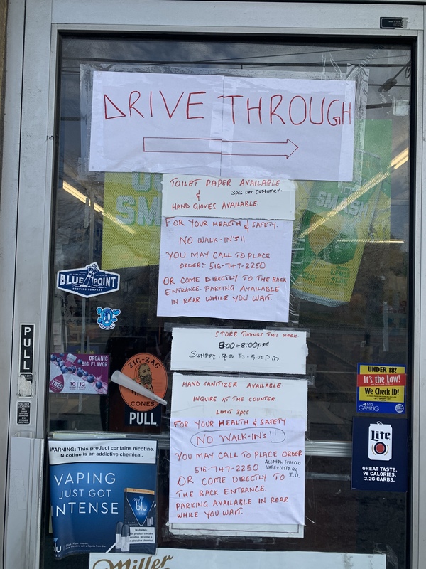 Multiple signs on a glass door discouraging walk ins. 