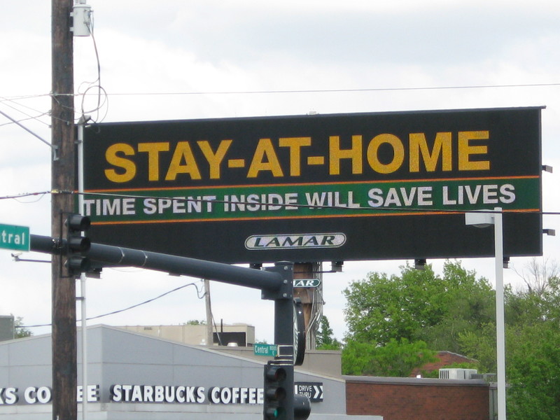 Billboard that reads stay inside, time spent at home will save lives.