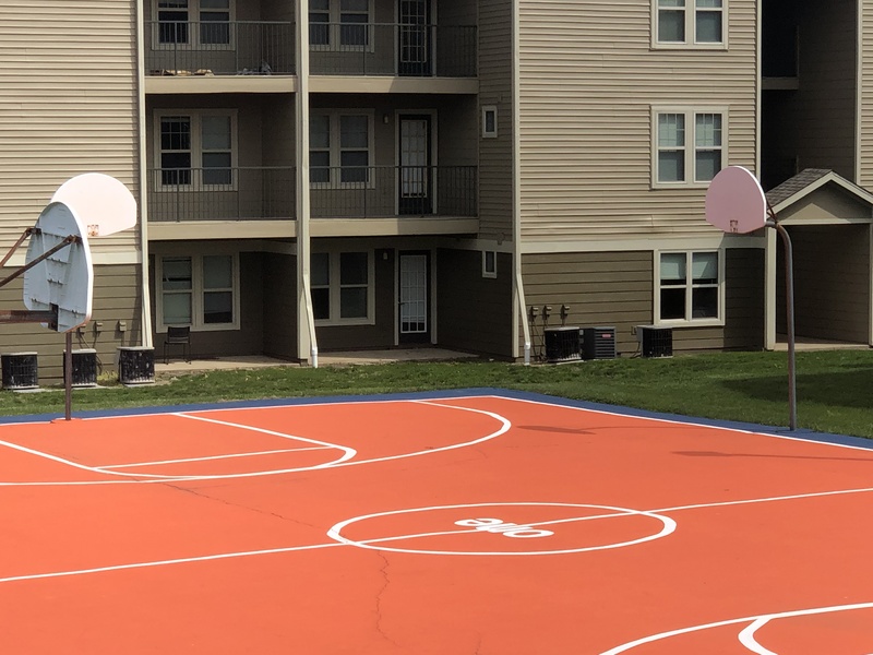 An empty orange basketball court.