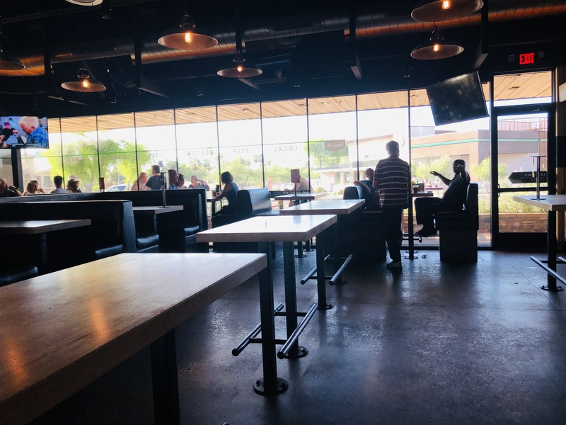 Photo of a restaurant with diners seated inside.