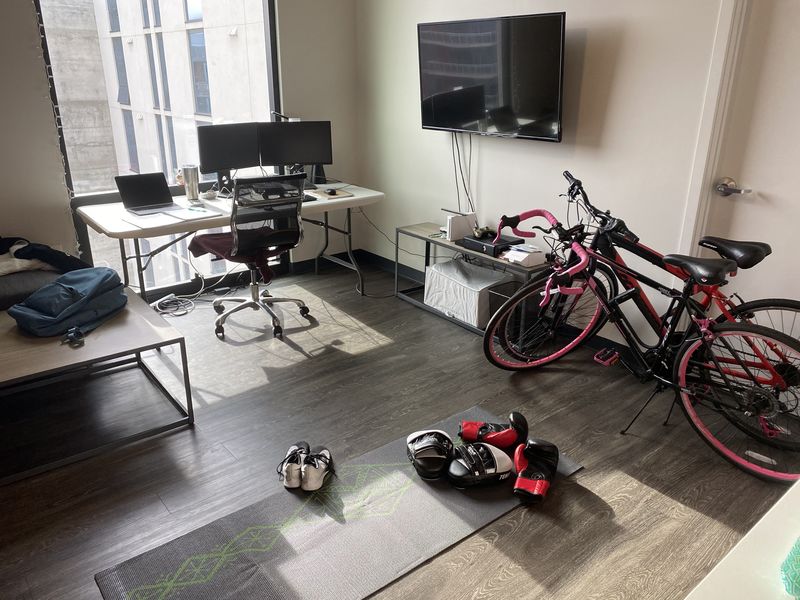 A living room with two bikes next to a door.