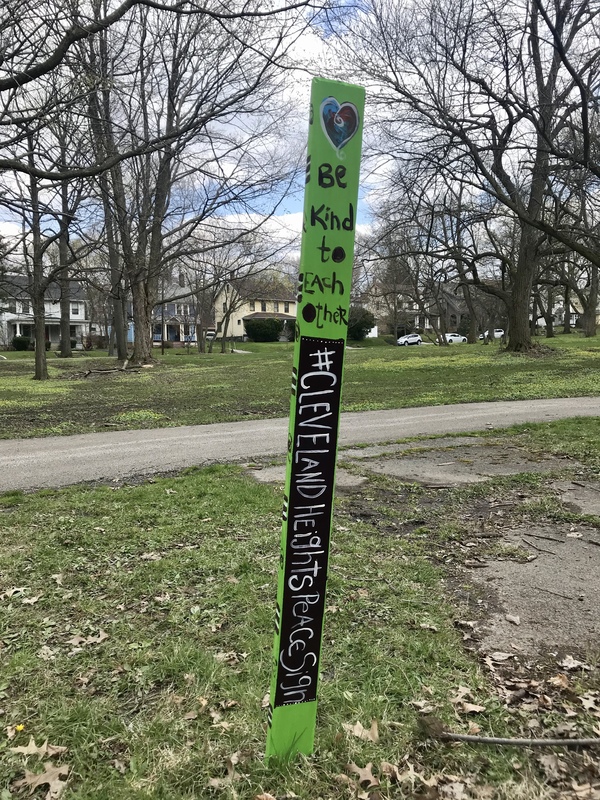 A neon sign that says "Be kind to each other". 