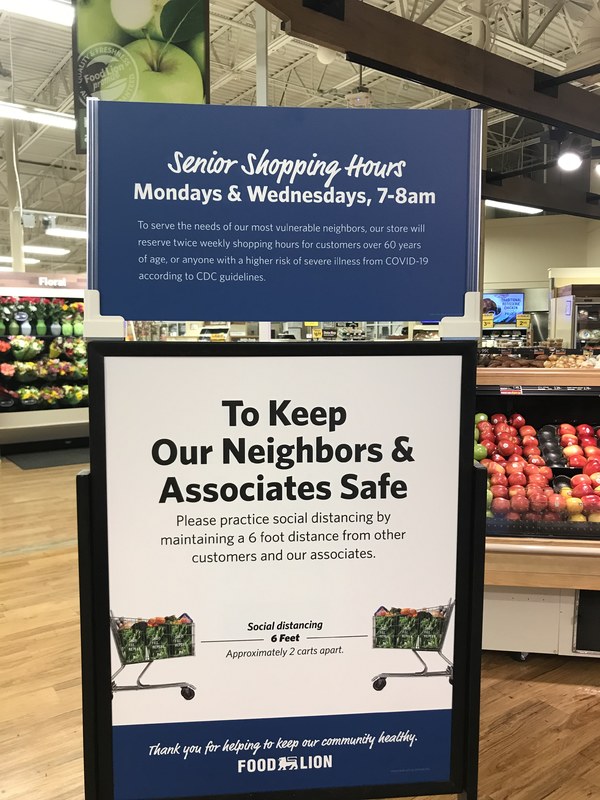 A blue and white sign in a supermarket. 